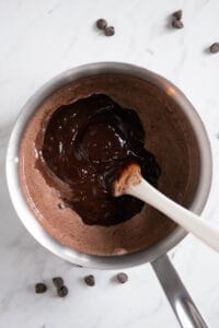 stirring chocolate into cream for chocolate fondue recipe.