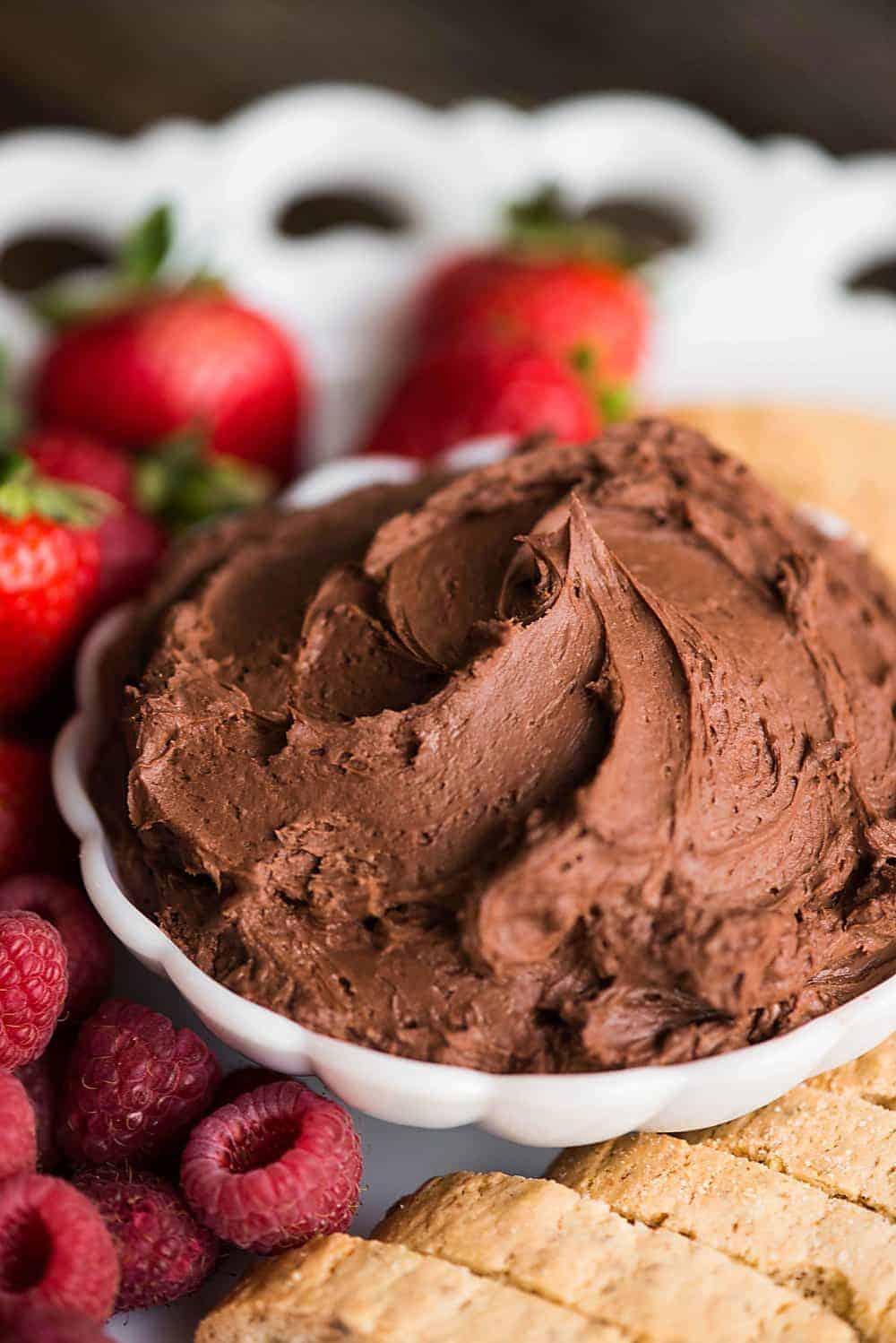 bowl of chocolate fruit dip with fruit and cookies