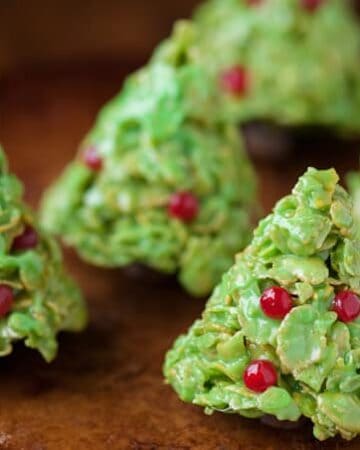 If you like Rice Krispie Treats, you'll love these holiday inspired Christmas Tree Corn Flake Treats, complete with decorations and a tootsie roll stump.