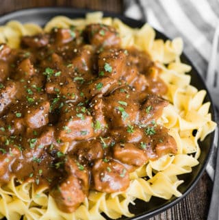 delicious plate of beef and noodles with brown mushroom gravy