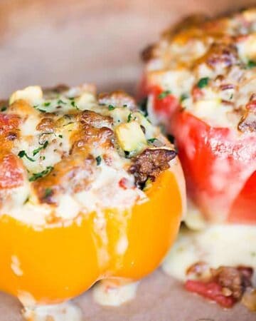 Classic Stuffed Peppers stuffed with rice, ground beef, tomatoes, and zucchini are a complete meal that can be made ahead.