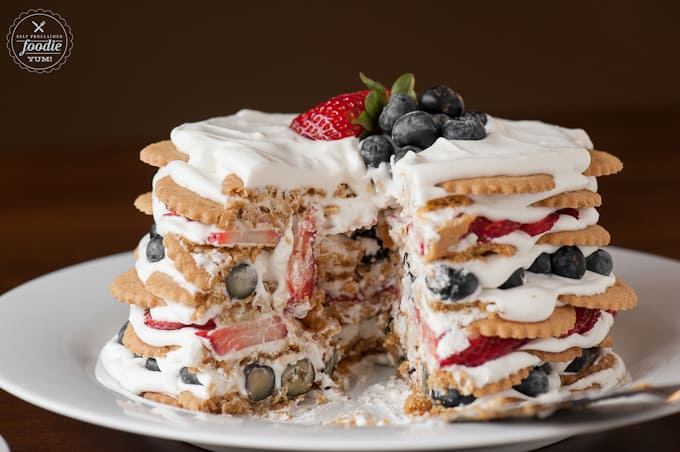 a slice taken out of a coconut berry icebox cake