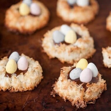 Coconut Caramel Easter Egg Nests made with coconut macaroons, salted caramel sauce, and chocolate candy eggs are the cutest little Easter desserts ever.