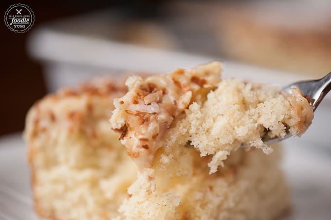 a bite of coconut pudding poke cake on fork