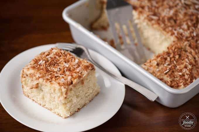 A slice of coconut poke cake on plate