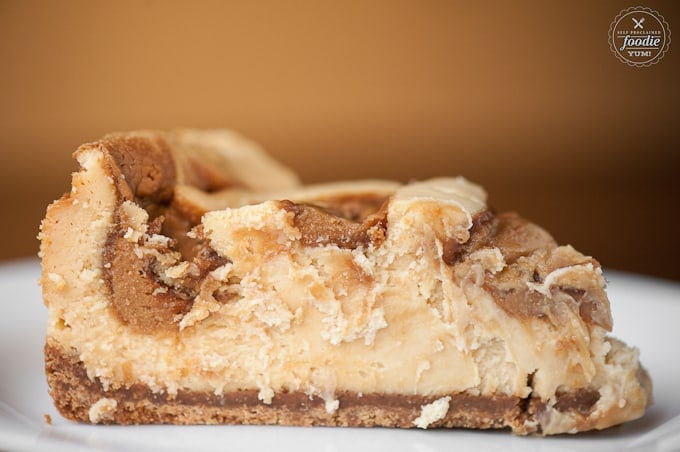 a close up of a slice of cookie butter cheesecake 