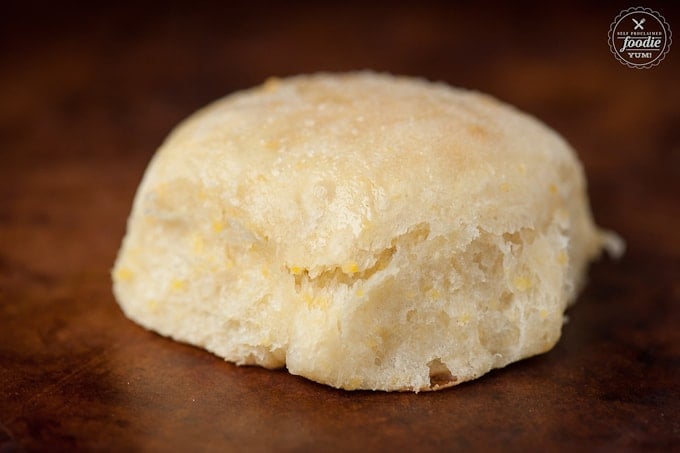 A close up of a roll made with cornmeal