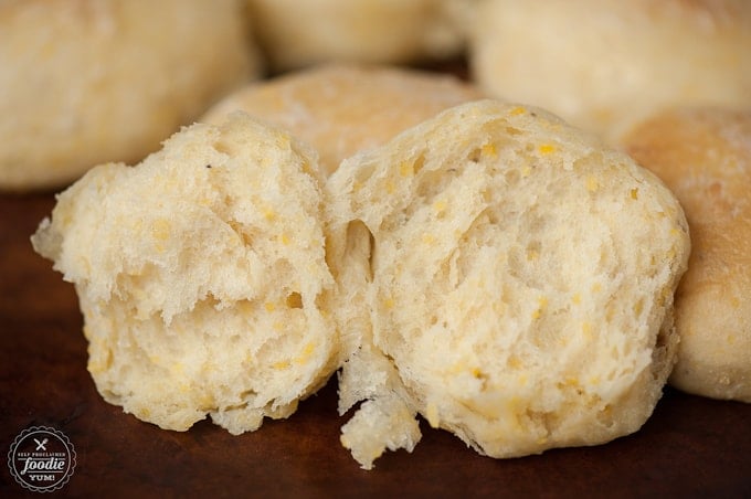 A close up of cornmeal yeast roll split in half