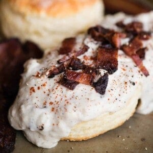 split biscuit with bacon gravy on top