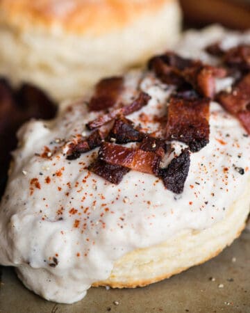 split biscuit with bacon gravy on top