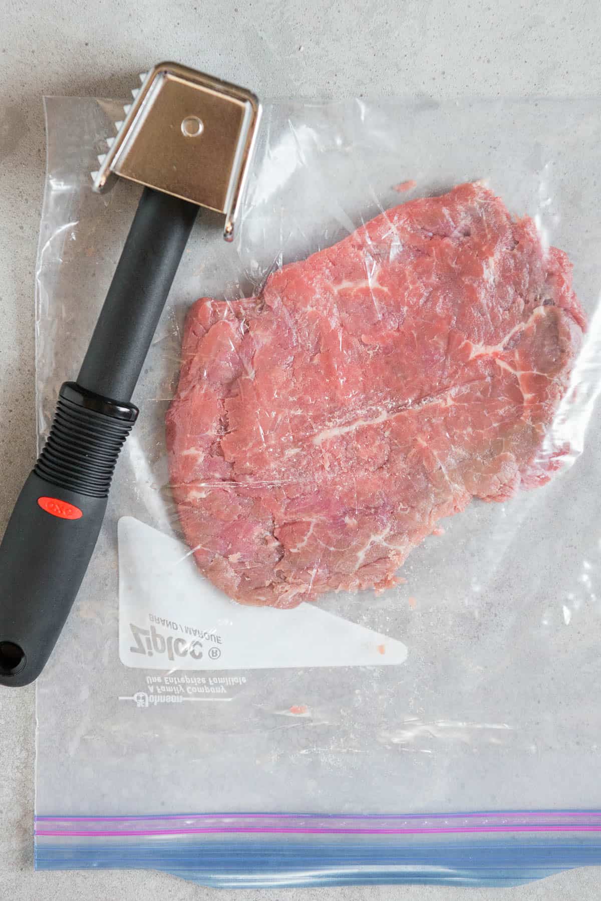tenderized round steak in plastic bag