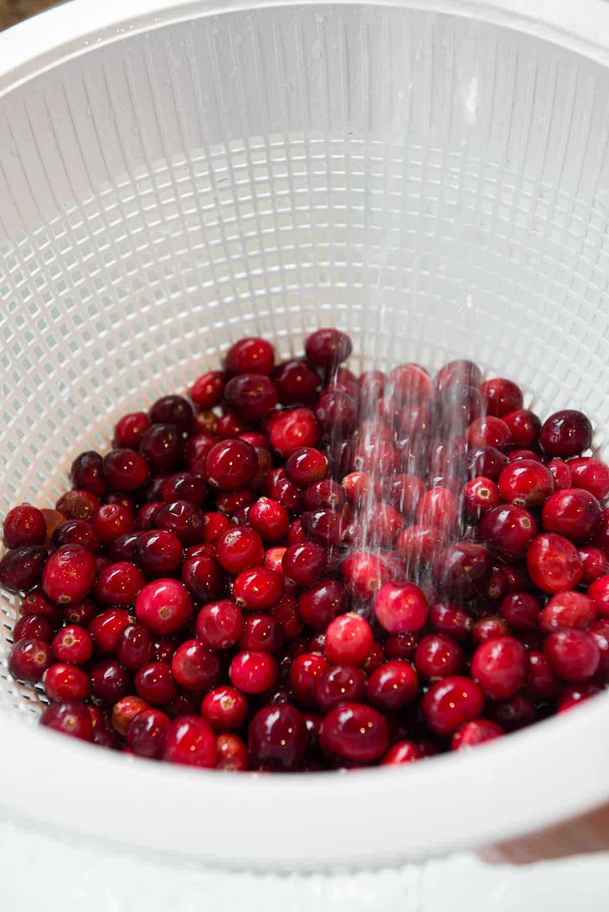 rinsing off fresh cranberries in strainer