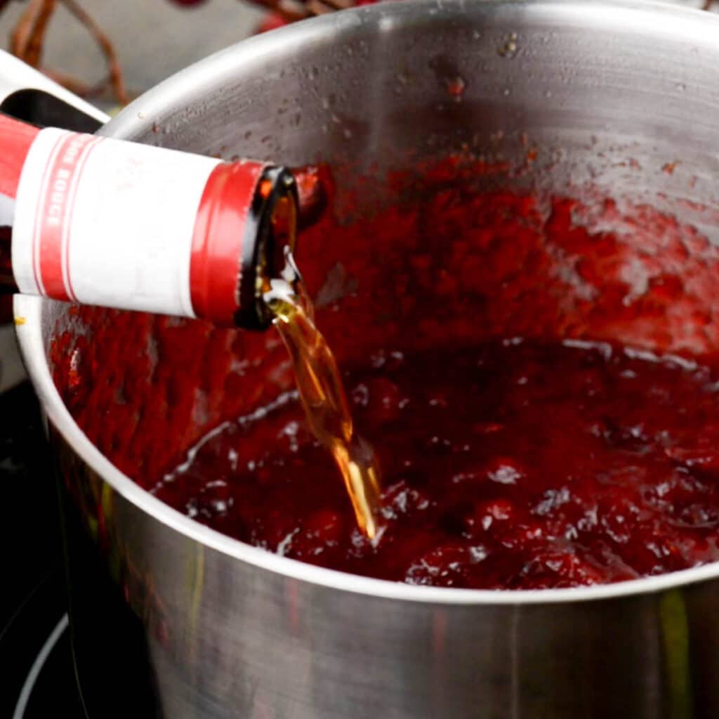adding Grand Marnier to homemade cranberry sauce