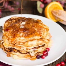 syrup covering a stack of homemade pancakes