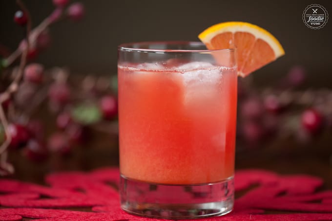 Cranberry Screwdriver with cranberry vodka, freshly squeezed orange juice, and a splash of Grand Marnier on a festive table