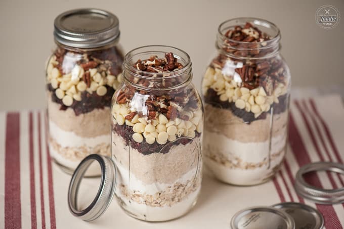 three jars of cranberry white chocolate mason jar cookie kits