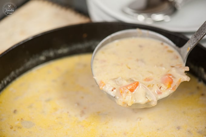 ladle full of creamy chicken soup