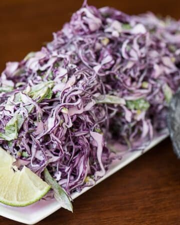 This Creamy Cilantro Lime Slaw combines fresh salad ingredients & a tangy dressing to make an outstanding side dish or your favorite fish taco topper.
