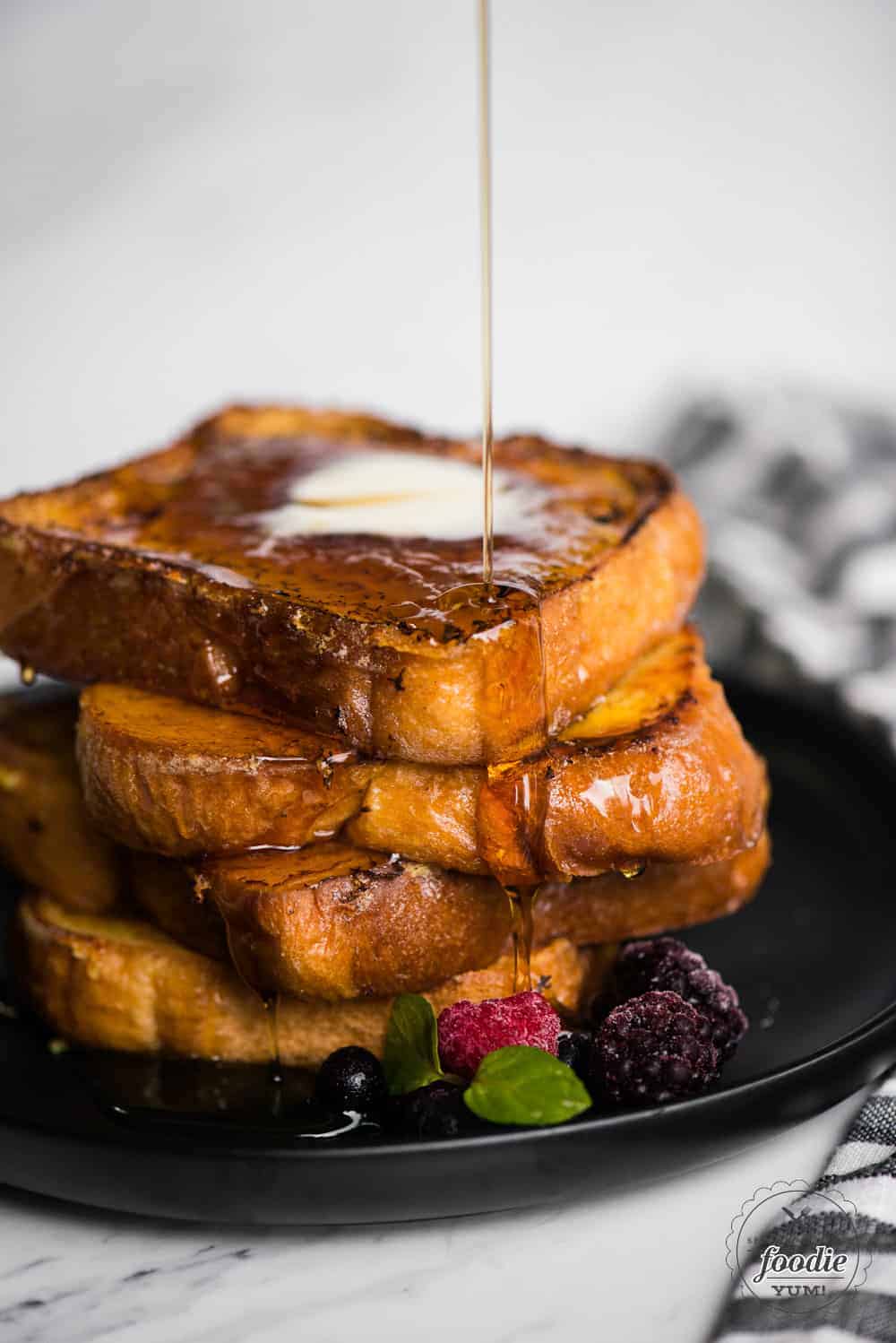pure maple syrup pouring over stack of Crème Brûlée French Toast