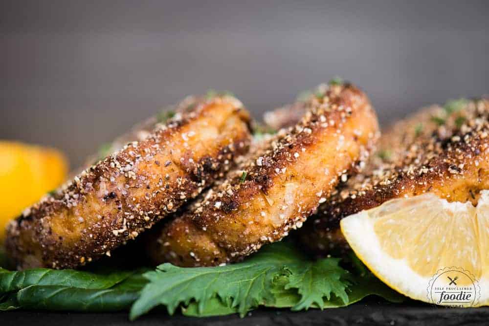 stack of salmon patties cooked in cornmeal with lemon