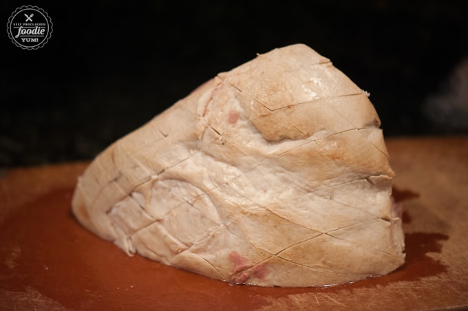 Uncooked cured whole ham where fat has been scored