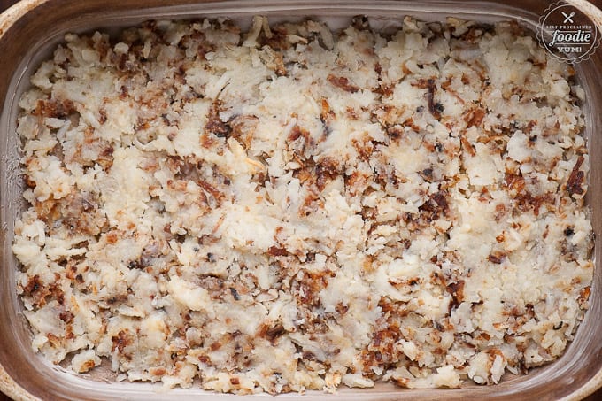 a baking pan filled with cooked hash browns for breakfast casserole