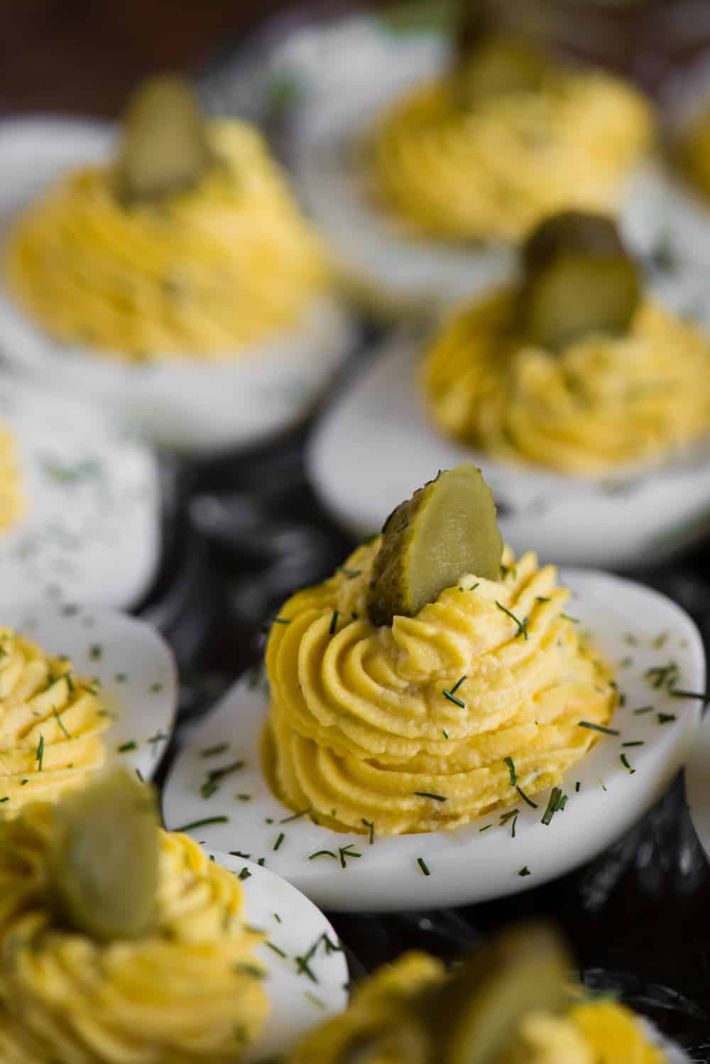a close up of a deviled egg with pickle