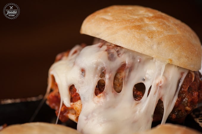 stuffed meatball slider sandwich with marinara sauce and lots of melted cheese