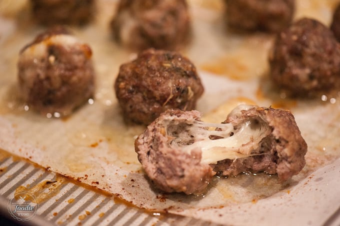 stuffed meatball pulled open with melted cheese