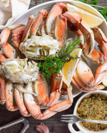 steamed Dungeness crab leg clusters with garlic herb butter.
