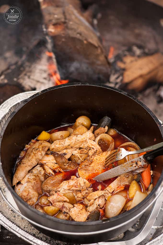 A pan filled with meat and vegetables, with Chicken and Dutch oven