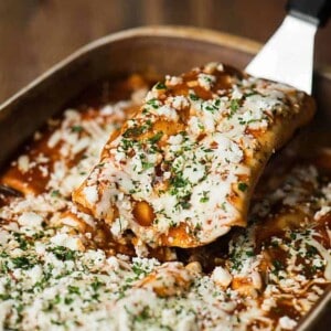 a scoop of easy ground beef enchiladas