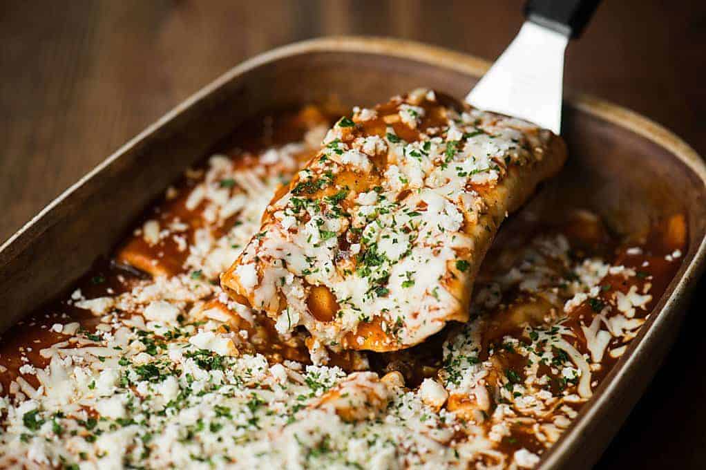 a scoop of easy ground beef enchiladas