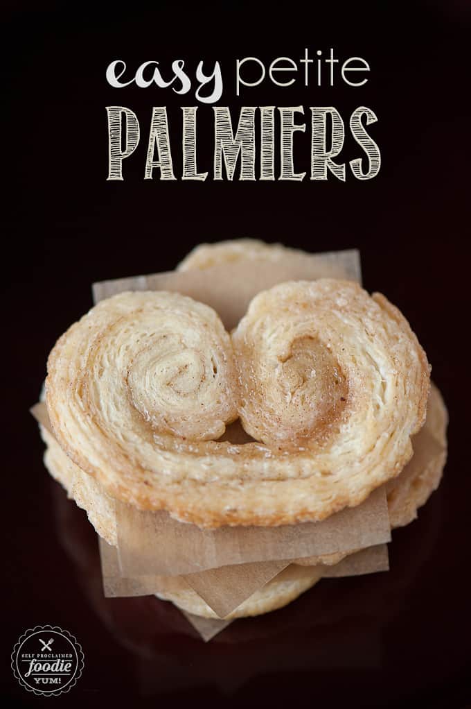 looking down at a stack of Palmier cookies separated with parchment paper