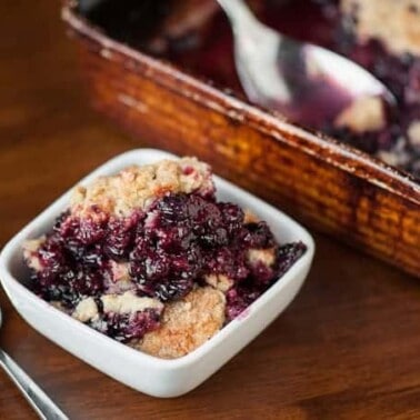 This Easy Quadruple Berry Cobbler with blueberries, blackberries, boysenberries, and blueberries is the perfect summer time dessert that everyone will love.