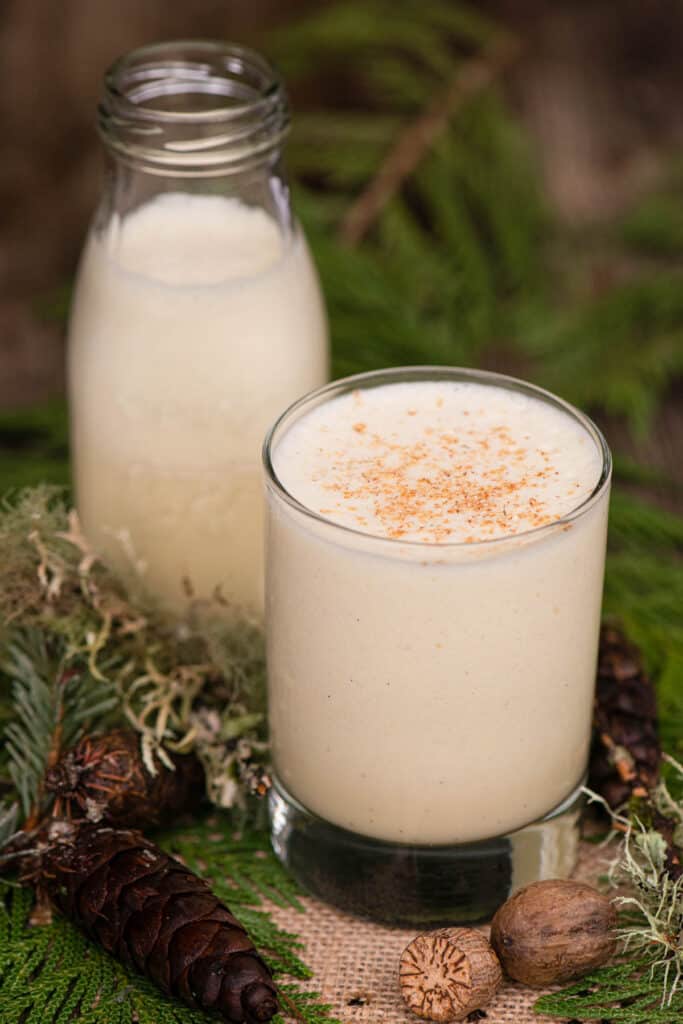 homemade eggnog in glass with festive holiday decor