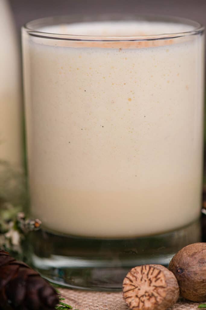 close up of homemade eggnog in glass with nutmeg