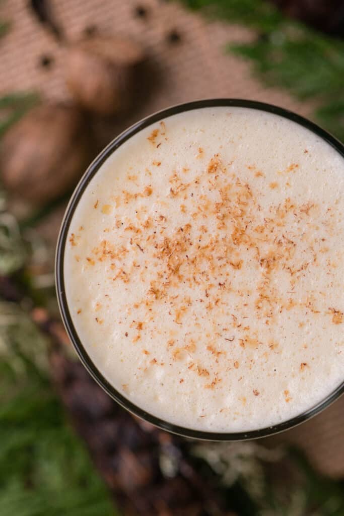 looking down at homemade eggnog with freshly grated nutmeg on top