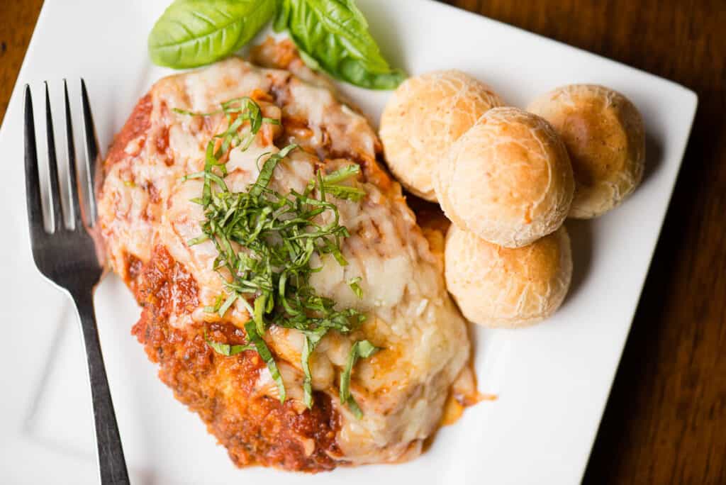 fried and baked eggplant parmesan on plate