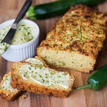 Freshly grated zucchini turns this no added sugar Cheddar Zucchini Bread with Jalapeno Honey Butter into a tasty sweet and savory summer quick bread.