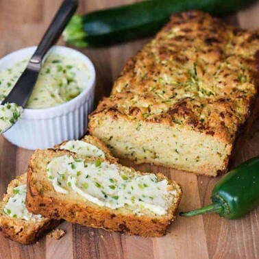 Freshly grated zucchini turns this no added sugar Cheddar Zucchini Bread with Jalapeno Honey Butter into a tasty sweet and savory summer quick bread.