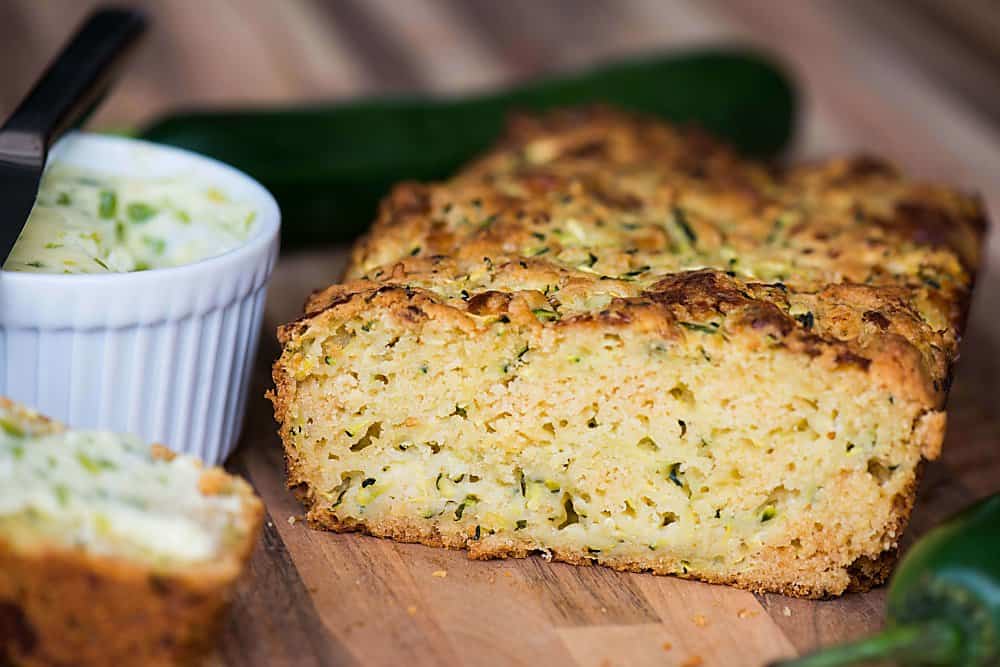 A close up of  a slice of cheddar zucchini bread