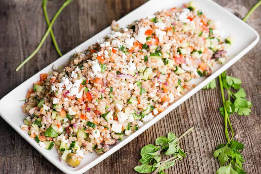 cooked farro salad with vegetables on platter