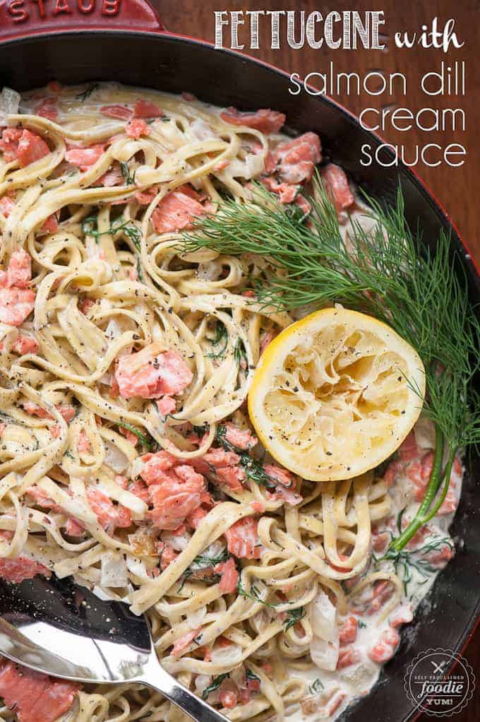 Fettuccine with Salmon and Cream Sauce in pan with lemon and dill