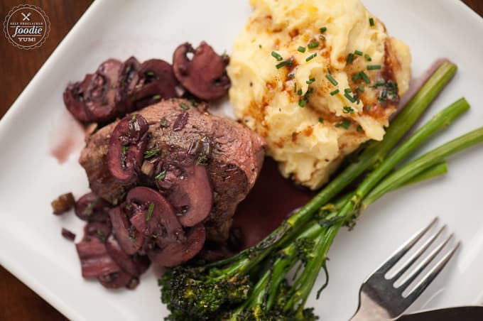 a plate of filet mignon with malbec mushrooms