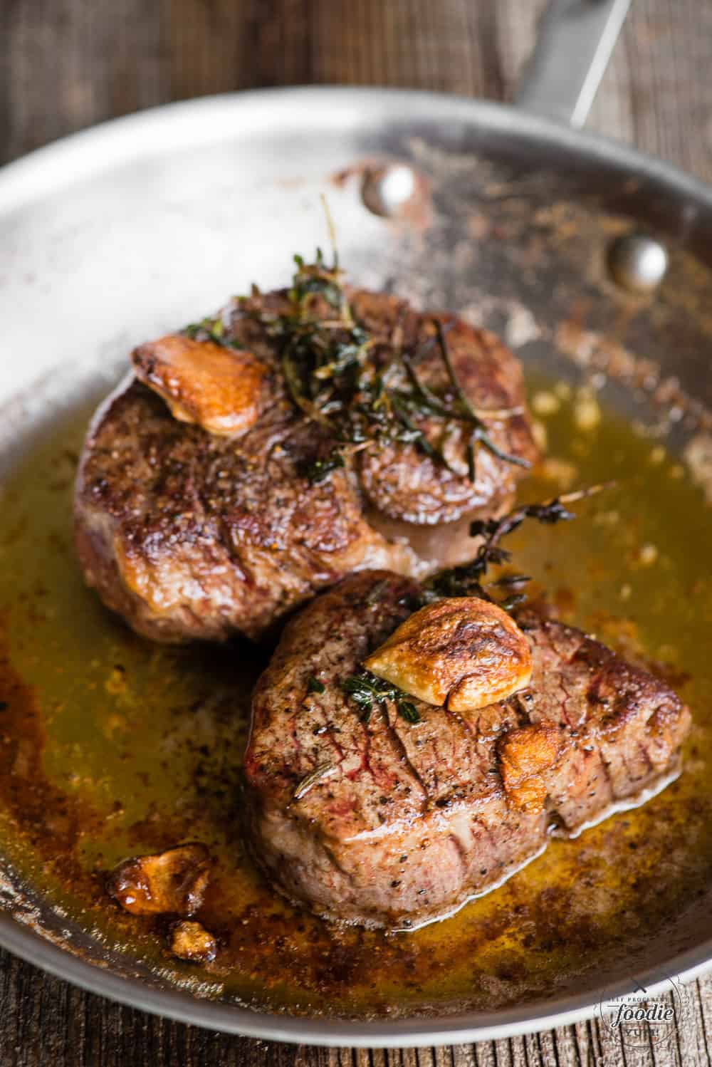 tenderloin steak in pan with garlic herb butter