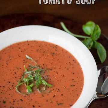 A bowl of tomato soup with basil