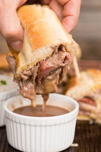 Dipping French Dip Sandwich in au jus