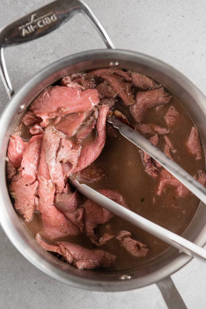 sliced beef warming in Au Jus