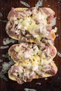 melted cheese on top of sliced beef